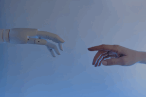 A human hand reaching toward a robotic hand, symbolizing connection and collaboration between humans and artificial intelligence.
